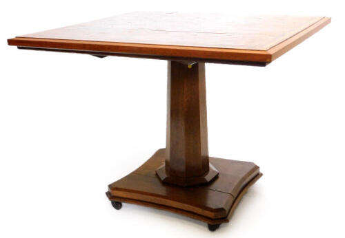 A Victorian oak and specimen timber breakfast table, the rectangular top inlaid in stylised brickwork, surrounding a central vacant cross shaped cartouche, within moulded walnut borders, on oak octagonal tapering column and concave platform, with brass ca