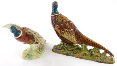 A Beswick pottery model of a pheasant, impressed and printed marks to underside, number 1225, and another Beswick model of a pheasant, (the smaller example AF), (2)