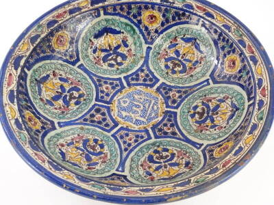 An Iznik pottery bowl, decorated with roundel's around a central inscription, inscribed mark to underside, 38cm diameter. - 2