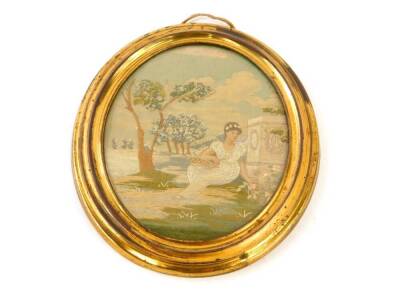 An early 19thC silk work picture of a lady in a classical garden setting, in oval gilt wood mount, with attribution to the back, 17cm x 14cm.