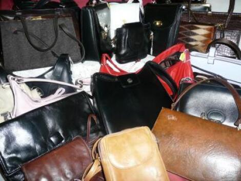 A large group of ladies handbags in various styles