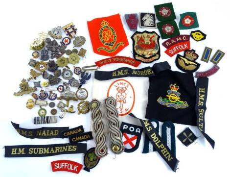 A quantity of military cap badges or tallies, military patches, badges, etc.