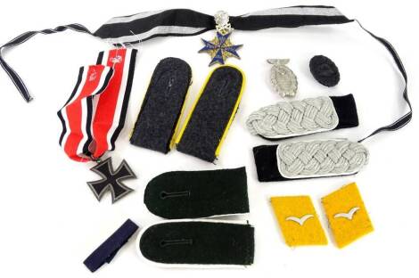 A quantity of World War Two reproduction badges, patches and awards.