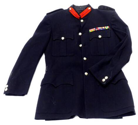 A post war British officer's tunic, with two ribbon bands and dispatches oak leaf.