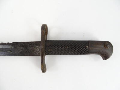 A late 19thC/early 20thC sawback bayonet, with leather and blackened metal scabbard, the blade stamped AS, 60cm long overall. - 2