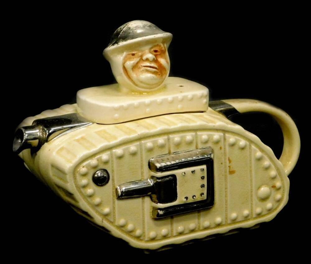 A Sadler type cream glazed tank shaped novelty teapot, the lid mounted
