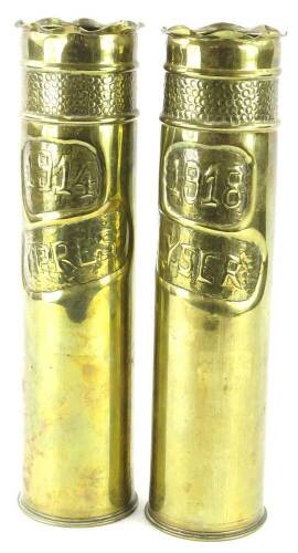 A pair of tall embossed brass Trench Art vases, engraved for Ypres 1914 and Yser 1918, the shells bearing various numbers etc., 33cm high.