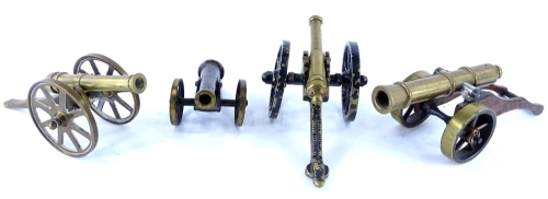 A collection of four miniature brass cannon, to include one to commemorate the Battle of Waterloo etc.