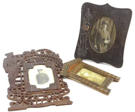 A collection of First World War related souvenir frames, to include a pierced example titled He Volunteered When Duty Called, inset with a photograph of a First World War soldier, another in a pill box shaped Trench Art frame and a photograph of a lady we