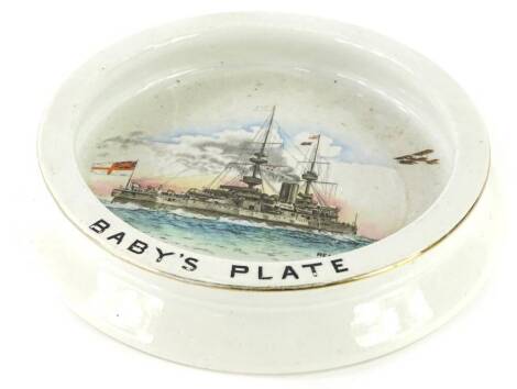 A Shelley ceramic baby's plate, printed and hand painted to the interior with a naval war ship, aeroplane, etc., titled Ready-Aye-Ready, printed makers mark to underside, 20cm diameter.