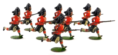 A set of eight Britains Black Watch charging lead soldiers, set eleven, 1904-1911, oval base edition.