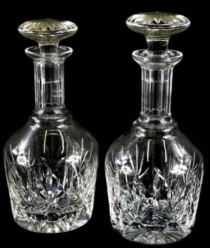 A pair of late 20th/early 21stC cut glass decanters, each with a facet cut stopper, 26cm high.