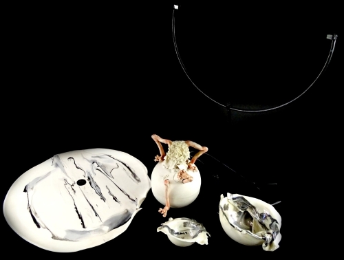 A collection of Studio Pottery, to include a figure hatching out of an egg, a ceramic plaque, decorated in grey and white coloured slips, with wrought iron stand and two similar dishes (4).