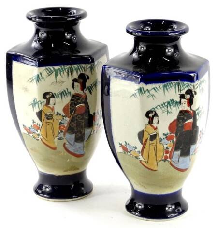 A pair of 20thC Japanese Satsuma vases, each decorated with figures, on a dark blue ground, 25cm high.