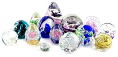 A collection of glass paperweights, various colours and models to include Langham, Caithness etc.