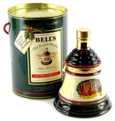 A bottle of Bells Christmas 1991 extra special whisky, in a bell shaped decanter, boxed.