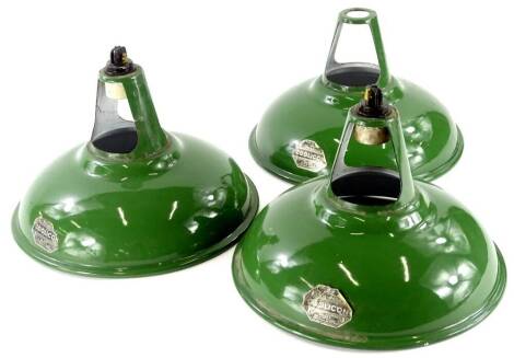 A set of three Coolicon green enamel industrial light shades, each with original labels, 28cm diameter.