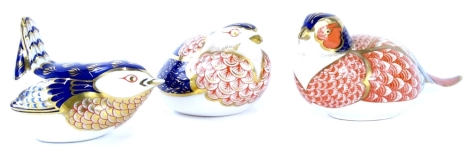 Three Royal Crown Derby porcelain paperweights, each modelled in the form of a bird, a pheasant, a wren and a partridge, printed marks in red to underside, all lacking stoppers.