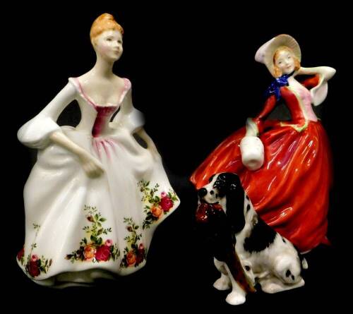 Two Royal Doulton figurines, Country Rose and Autumn Breezes, and a Royal Doulton figure of a spaniel with pheasant HN1062. (3)