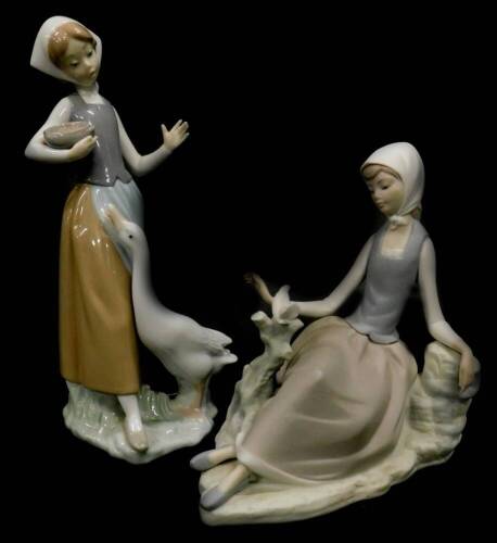 A Lladro matt glaze figure of a lady seated beside a dove, and another figure of a lady with a goose. (2)