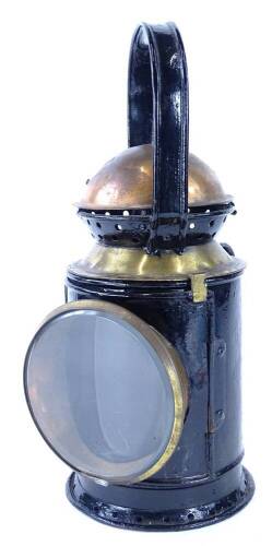 An ebonised metal and copper and brass Railway type lamp, with thick bevelled glass number plaque to side, 19518, 35cm high.