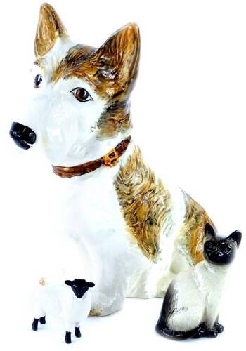 A Sylvac model of a terrier, 28cm high, a Beswick seated Siamese cat and a Beswick matt glazed lamb.