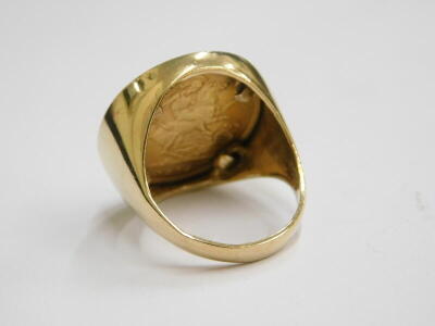 A George V half gold sovereign ring, dated 1914 in a 9ct gold ring setting, ring size O½, 9.7g. - 2