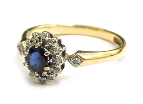 A 9ct gold cluster ring, the central cluster set with white and blue stone, each in claw setting with tiny diamond set shoulders, all in a raised platinum setting on a plain yellow metal band, ring size N, 2.1g.