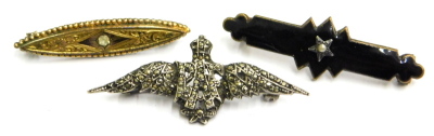 Three bar brooches, comprising a silver and marcasite set RAF wings brooch, a jet and seed pearl set bar brooch, and a gold plated and single stone set bar brooch. (3)