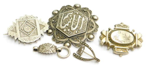 Four silver brooches, to include a Middle Eastern brooch, with filigree type design and lettering to centre, 6cm wide, a silver memorial panel backed brooch, 4.5cm wide, a silver plated and brass backed brooch depicting a bird, 5cm wide, a silver marcas