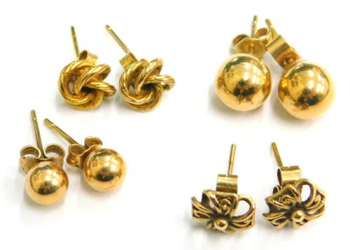 Four pairs of 9ct gold stud earrings, comprising a larger and smaller set of ball studs, a pair of knots and a pair of floral design sprays, each with butterfly backs, 5.2g.