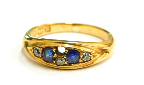 An 18ct gold sapphire and diamond set gypsy ring, set with two sapphires and design for four diamonds (one missing), ring size J, 2.9g all in.