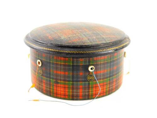 A late 19thC Clark & Co. Paisley tartan ware cotton box, of circular form with removable lid, set with thimble and cotton reels, with inner label, 10cm diameter.