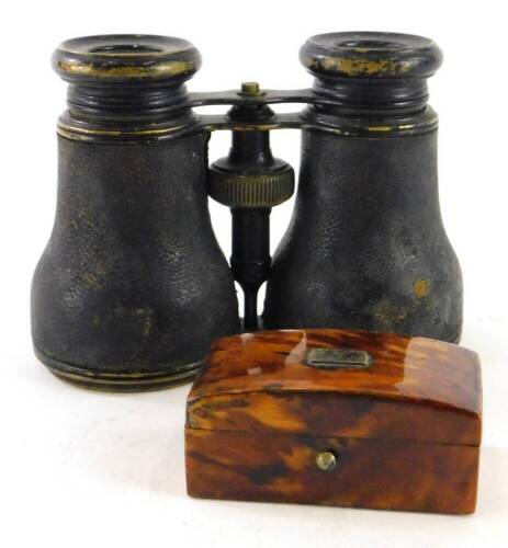 A late 19thC tortoiseshell patch box with domed lid and vacant white metal cartouche, 6cm wide, and a pair of early 20thC opera glasses in metal casing (2).