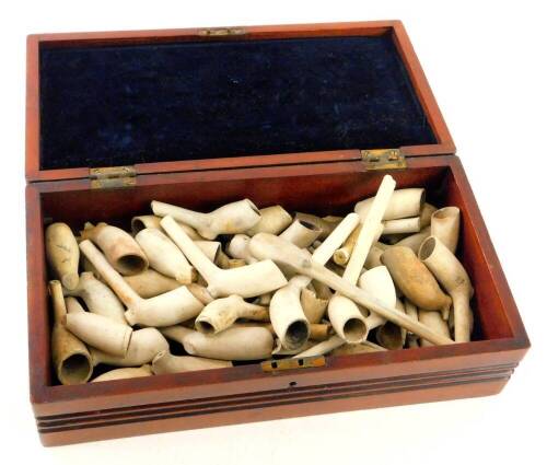 Various clay pipes 19thC and others, some earlier, 15cm wide, etc., contained in a mahogany box.