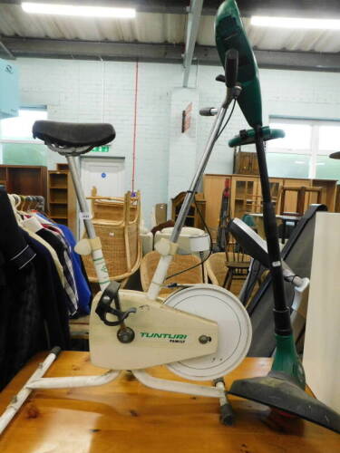 A Tunturi exercise bike, and a Black and Decker GLC2500 strimmer. (2)