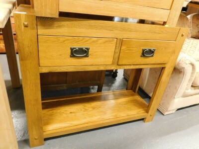 An oak two drawer side cabinet, with under tier.