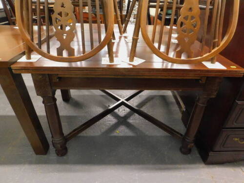A mahogany extending dining table, on 'X' shaped stretcher.
