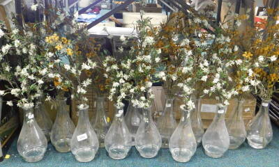 A quantity of plant pots, artificial flowers, glass bud vases, etc. (contents of under one table).