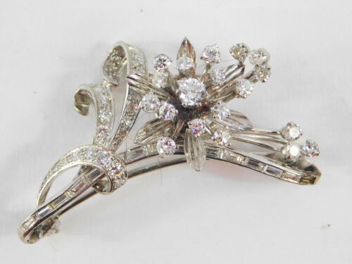 A diamond set floral spray brooch, baguette and brilliant cut diamonds, set in white metal, approximately 1.7cts, 11.7g.