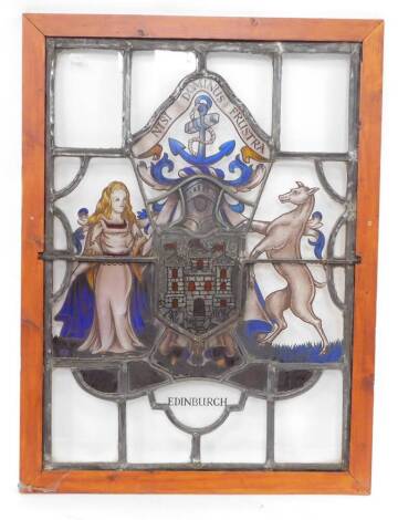 A stained glass window panel, pine framed, bearing the Coat of Arms and Motto of the City of Edinburgh, 85cm high, 61cm wide.