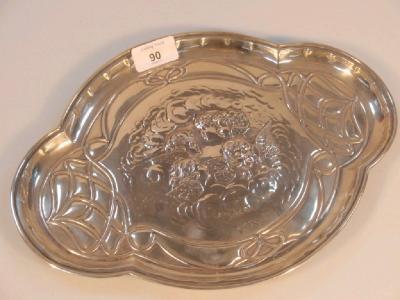 An Edwardian silver dressing table tray of quatrefoil form embossed with angle masks