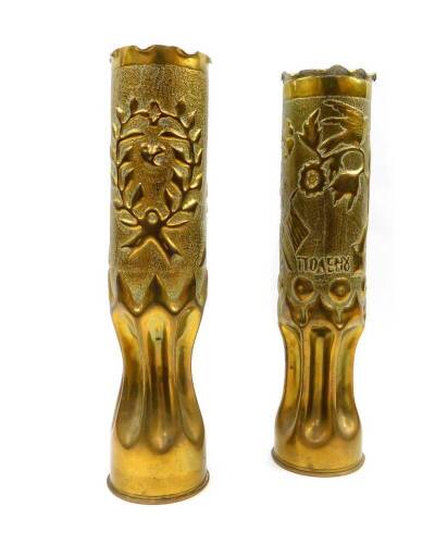 A pair of Greek WWI trench art brass shell cases, one embossed with crossed flags, a crown, flowers, script and dated 1913., the other with a heart enclosed within a wreath, pot and flowers, dated 1919, 34.5cm high.