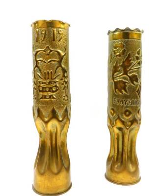 A pair of Greek WWI trench art brass shell cases, one embossed with crossed flags, a crown, flowers, script and dated 1913., the other with a heart enclosed within a wreath, pot and flowers, dated 1919, 34.5cm high. - 2