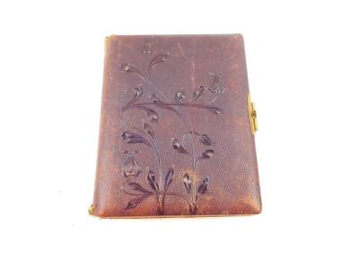 A Victorian cloth bound photograph album, embossed with flowers, with brass clasp, opening to reveal floral illustrated pages, 21.5cm wide, 28cm deep. - 2