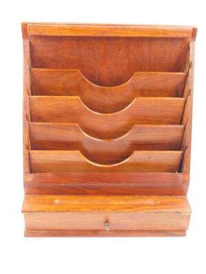 A 1950's hardwood desk organiser, with a waterfall five tier stationery rack, pen recess and single frieze drawer, raised on a plinth base, 34cm high, 30cm wide, 16cm deep.