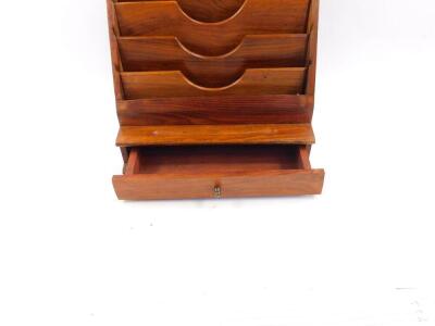 A 1950's hardwood desk organiser, with a waterfall five tier stationery rack, pen recess and single frieze drawer, raised on a plinth base, 34cm high, 30cm wide, 16cm deep. - 2