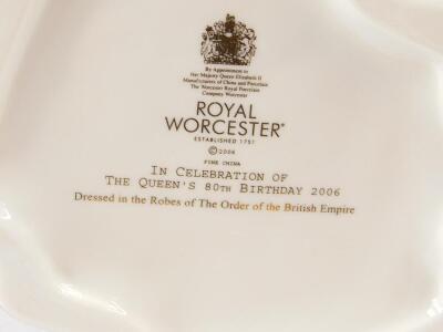 A Royal Worcester porcelain figure of Her Majesty The Queen, In Celebration of The Queen's 80th Birthday 2006, dressed in the robes of the Order of The British Empire., together with a figure of Her Majesty Queen Elizabeth II, In Commemoration of the Diam - 2