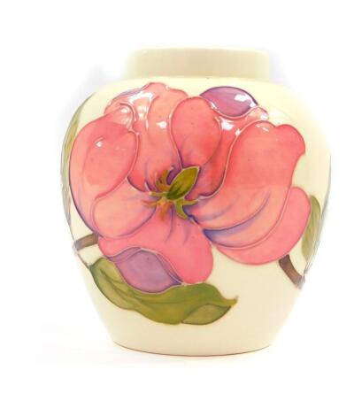 A Moorcroft pottery ginger jar decorated in the Magnolia pattern, lid lacking, painted and impressed marks, 14cm high.