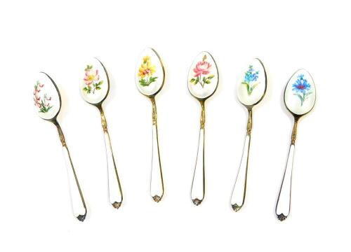 A set of six silver gilt and enamel coffee spoons, painted with flowers against a white guilloche and enamel ground, cased, Elkington & Company, Birmingham 1962, 2.23oz.